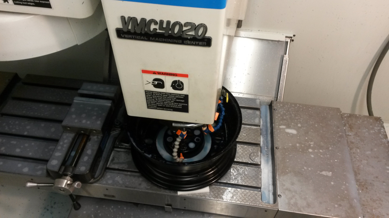 Enlargening the center hole on the wheels with a milling machine.
